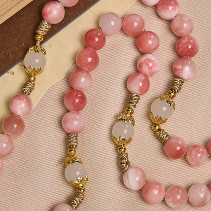Rosario con perline rosa lucide, fatto a mano, con crocifisso in ottone e medaglietta della Madonna