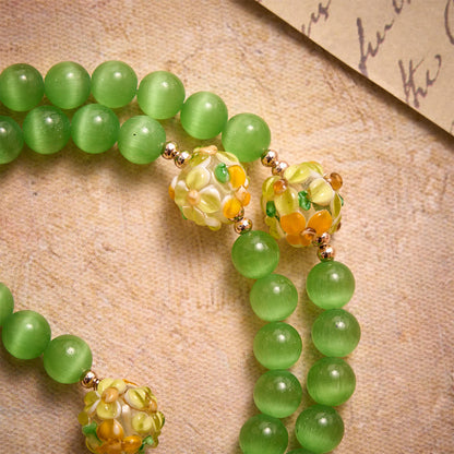 in pietra occhio di gatto verde con perle in vetro lampwork a fiore: simbolo di vive benedizioni celesti