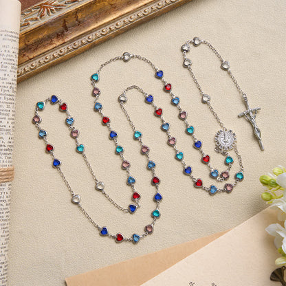 Rosario in argento con cuore e zircone e medaglia di San Benedetto: simbolo di dolce grazia celeste