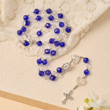Rosario in vetro cavo a forma di cuore con perline sfaccettate blu scuro: segno di costante protezione divina
