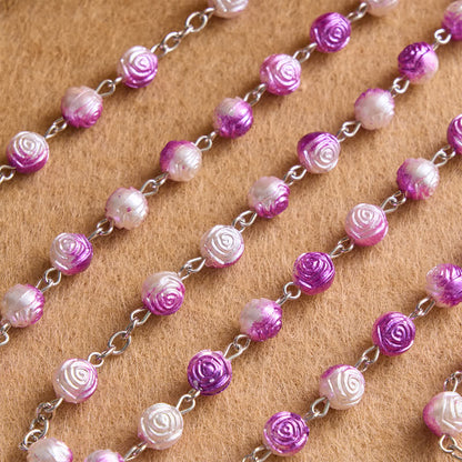 Rosario celeste con grani a forma di rosa e crocifisso: Distintivo di guida costante